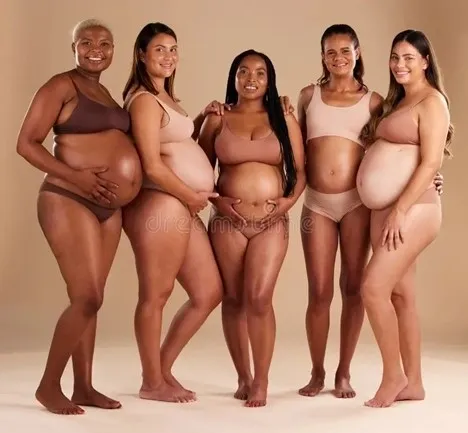 A group of pregnant women standing next to each other.