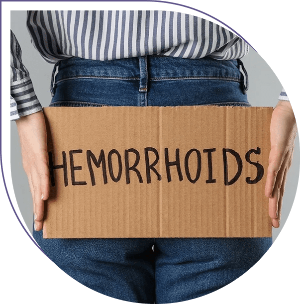 A person holding a cardboard sign that says hemorrhoids.